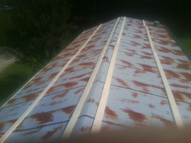 Rusted metal roof panels with new wood purlins before replacement — Storm Damage Roof Repair in Burnham by Roofing Brothers